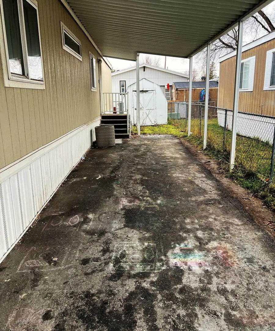 The same carport swept and empty after K Bye hauled it off